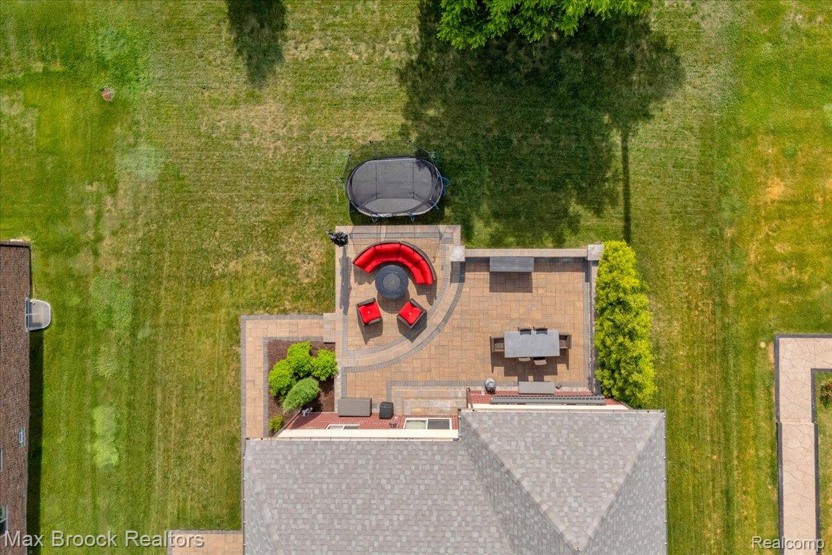 1126 Queensboro Drive Rochester, MI 48307 - Photo 61 of 66 Spacious patio area featuring paver stone construction, multiple distinct zones, and integrated landscaping