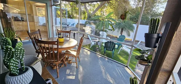 a balcony with table and chairs