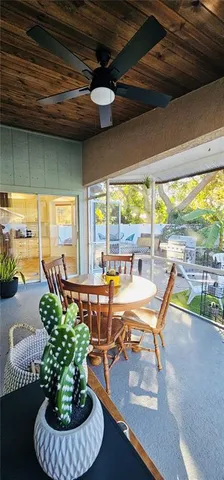 a living room with patio furniture and a large window