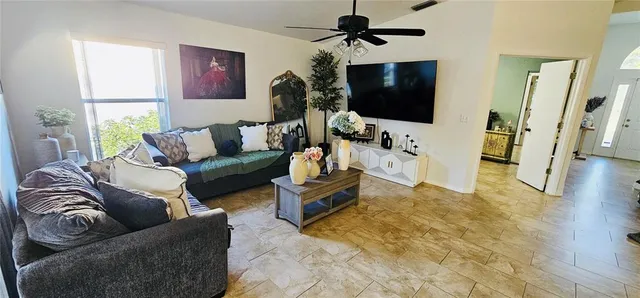 a living room with furniture and a flat screen tv