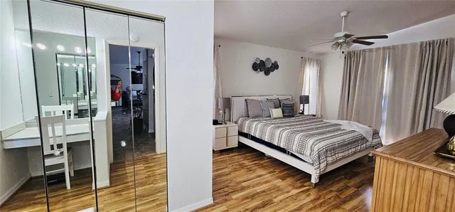 a bedroom with a bed and a mirror