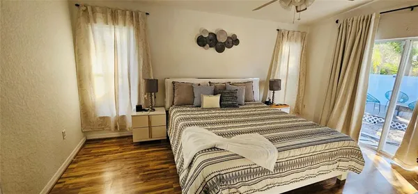 a bedroom with a bed and wooden floor