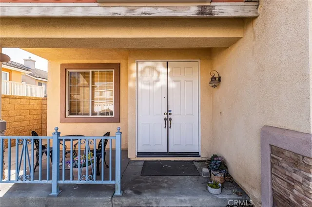 a view of a house with wooden fence