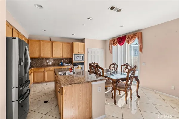 a kitchen with granite countertop lots of counter top space and stainless steel appliances