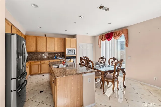 a kitchen with granite countertop lots of counter top space and stainless steel appliances