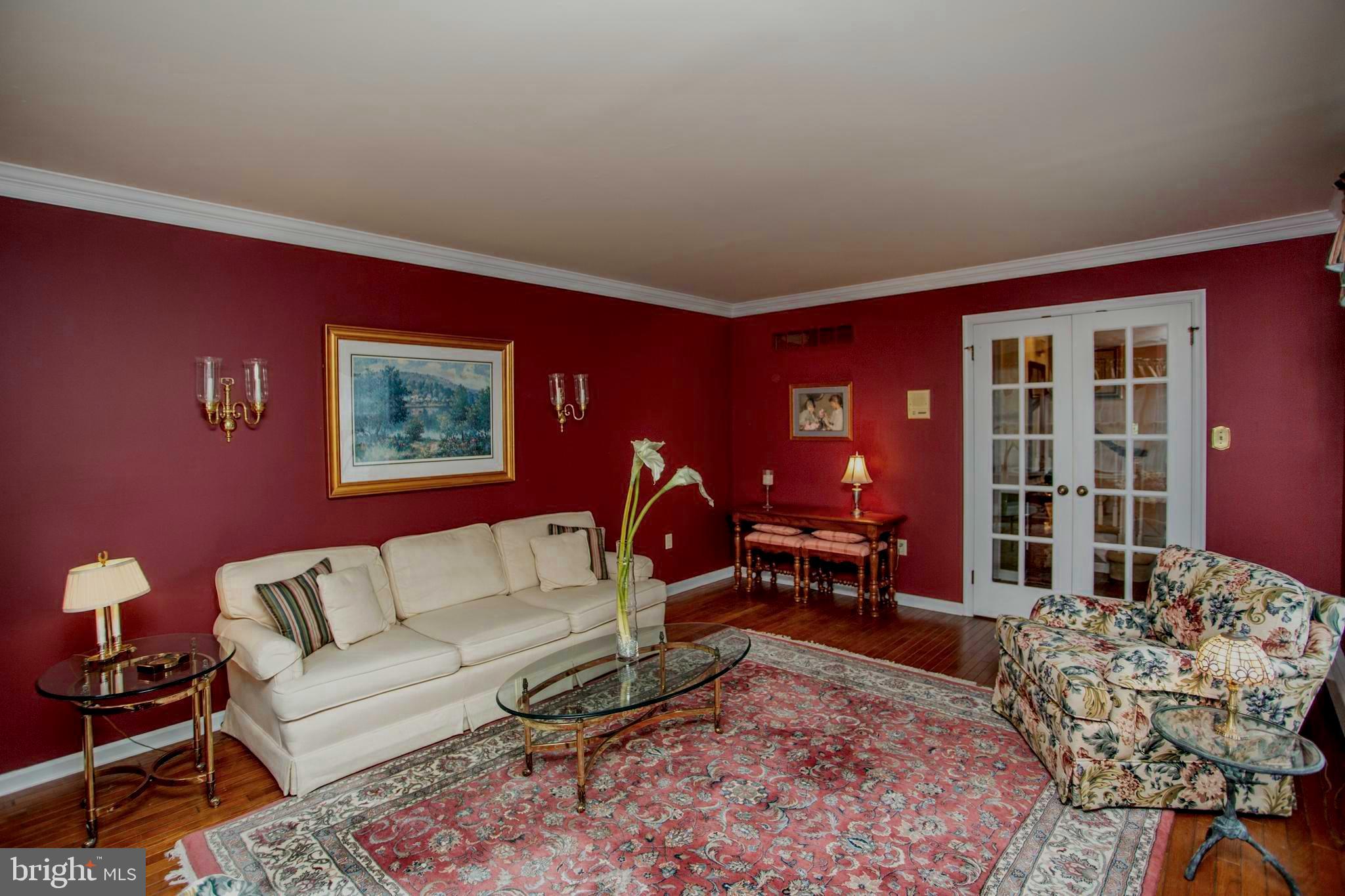950 Camelot Road Furlong, PA 18925 - Photo 24 of 106 a living room with furniture a dining table and chairs with wooden floor