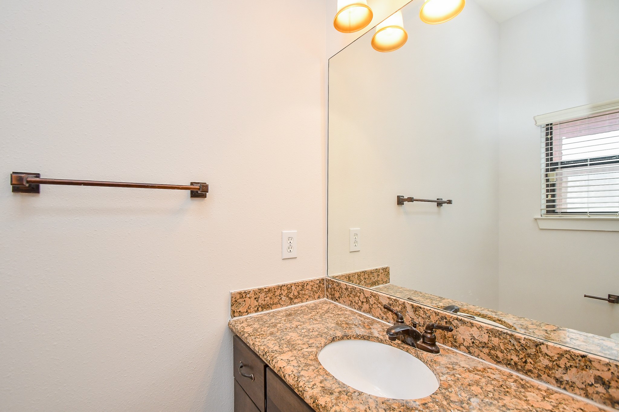2422 Navigation Boulevard, Unit A Houston, TX 77003 - Photo 14 of 32 a bathroom with a granite countertop sink and a mirror