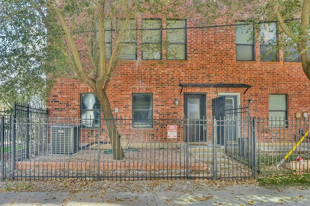 a view of a brick house with large windows
