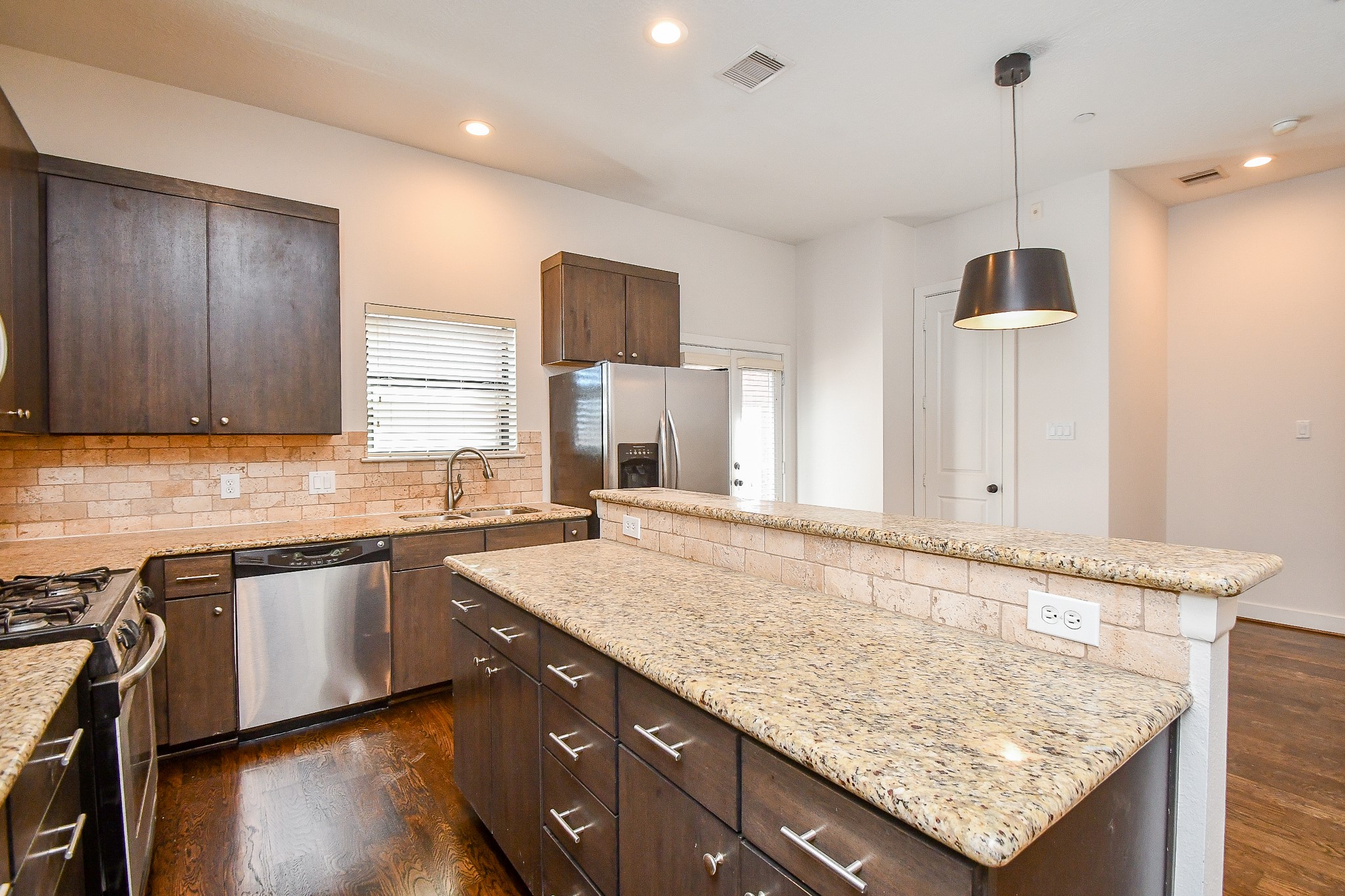 2422 Navigation Boulevard, Unit A Houston, TX 77003 - Photo 7 of 32 a kitchen with granite countertop kitchen island sink and cabinets