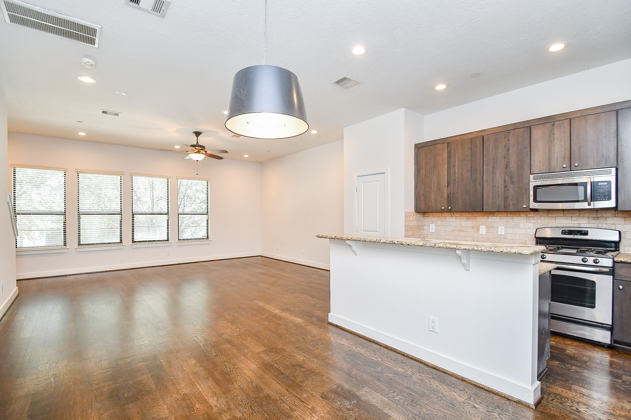 2422 Navigation Boulevard, Unit A Houston, TX 77003 - Photo 8 of 32 a kitchen with stainless steel appliances granite countertop a stove a sink and a microwave