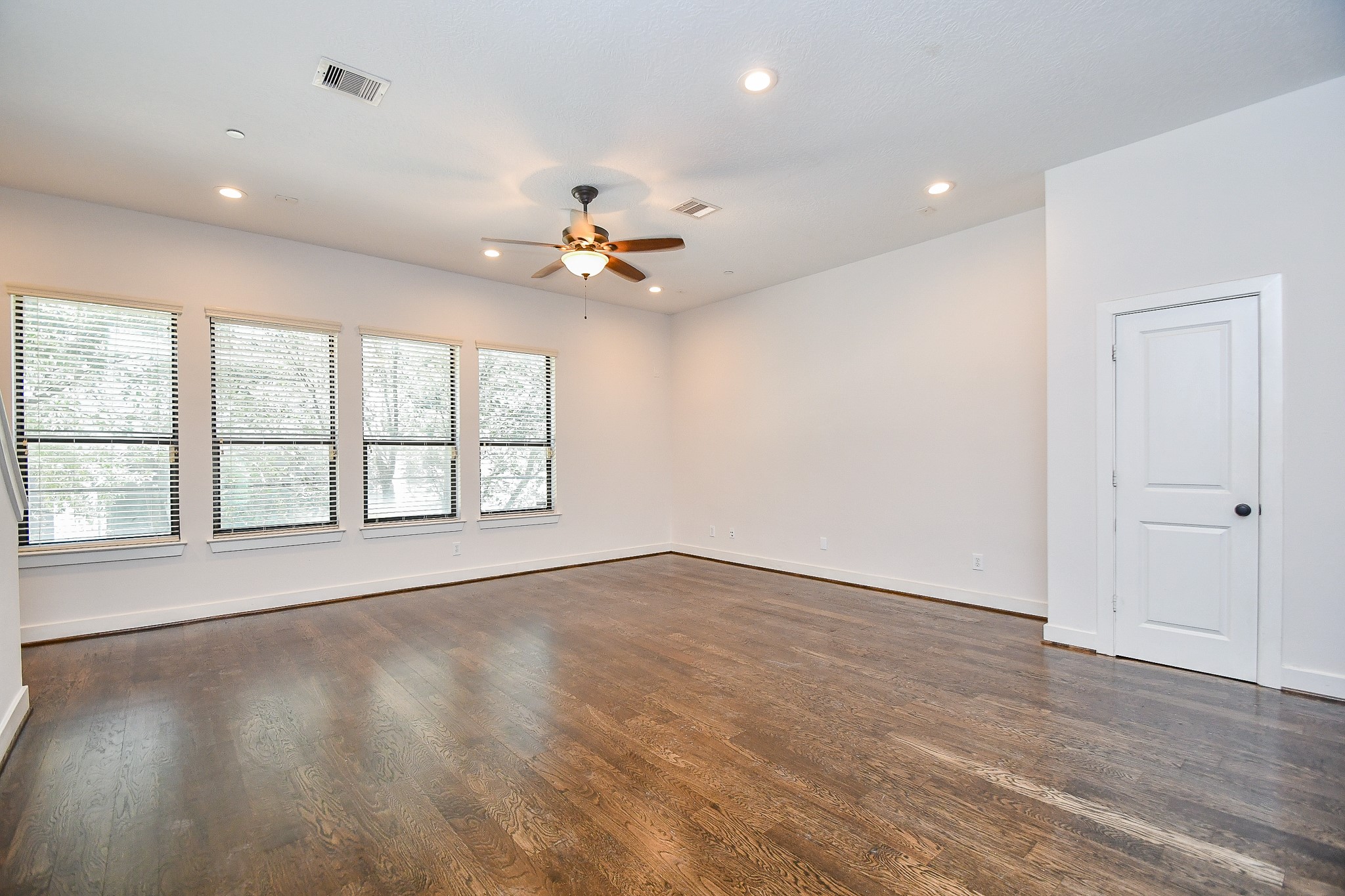 2422 Navigation Boulevard, Unit A Houston, TX 77003 - Photo 10 of 32 an empty room with wooden floor and windows