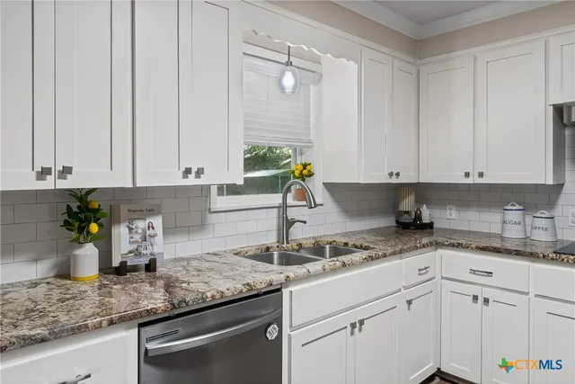 a kitchen with sink cabinets and window