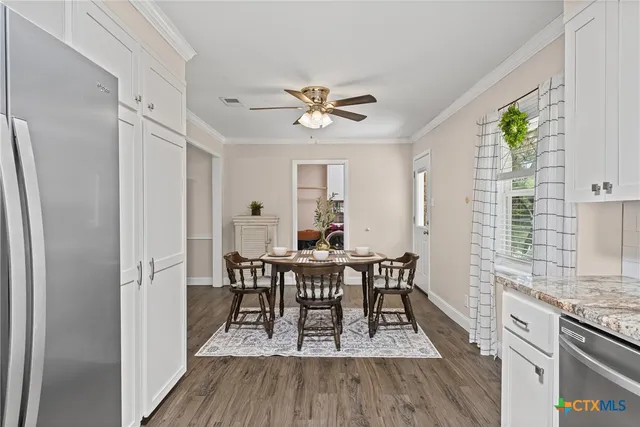 a view of a dining room with furniture and wooden floor