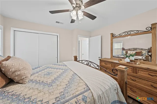 a bedroom with a large bed and a chandelier