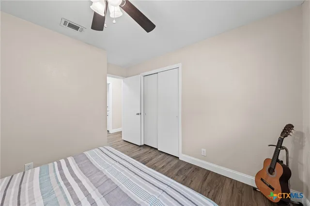 a view of a room with wooden floor and air conditioner