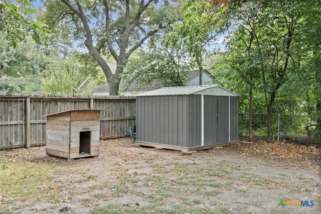 a backyard of a house with a tree