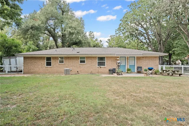 a view of a house with a backyard and a garden