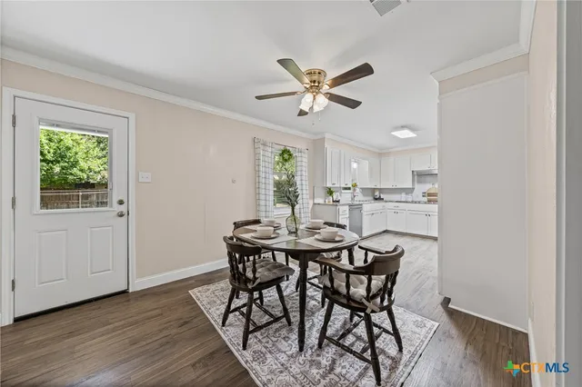 a view of a dining room with furniture and a window