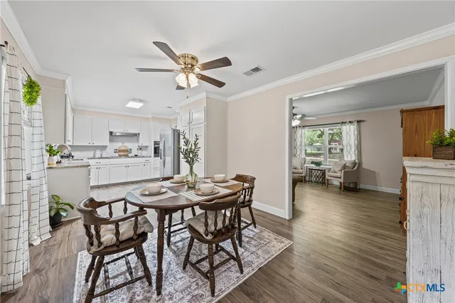 a view of a dining room with furniture and a livingroom