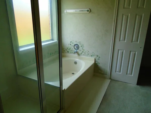 a bathroom with a bathtub and a shower