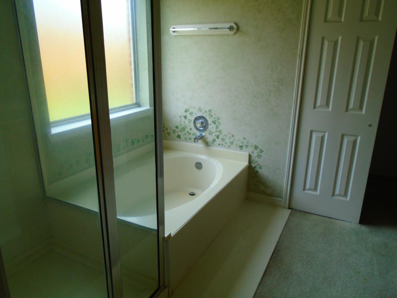 7817 Duchess Street Corpus Christi, TX 78413 - Photo 11 of 11 a bathroom with a bathtub and a shower
