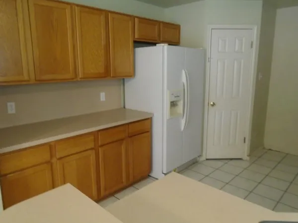 a white refrigerator freezer sitting in a kitchen