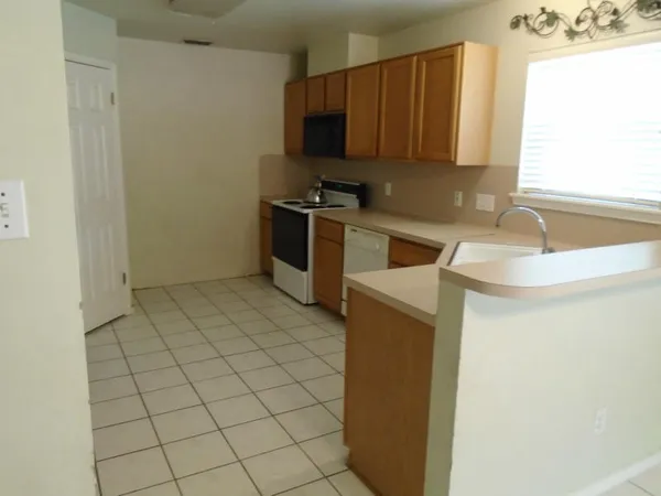 a kitchen with a sink and a stove top oven