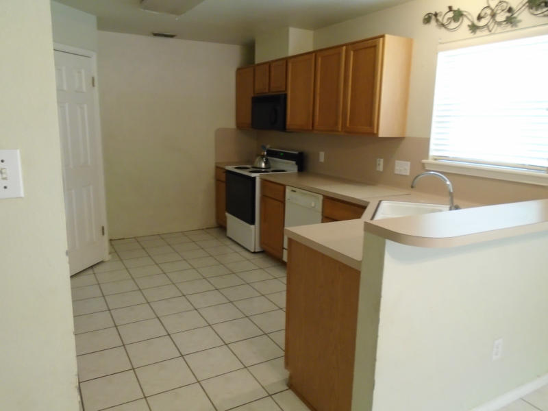 7817 Duchess Street Corpus Christi, TX 78413 - Photo 6 of 11 a kitchen with a sink and a stove top oven
