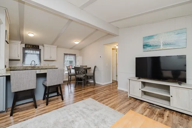 a living room with a flat screen tv and a fireplace