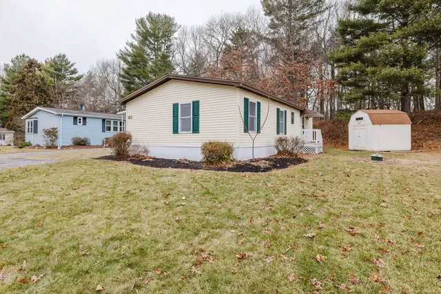 a view of a backyard with large trees