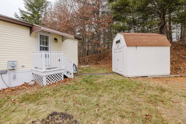 a view of a yard with furniture and wooden fence