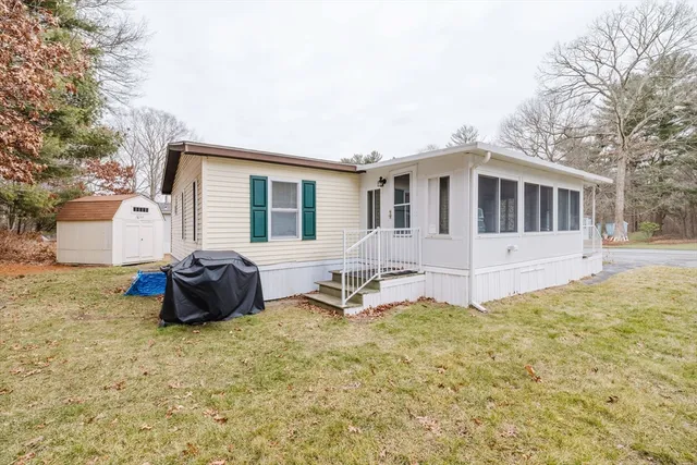 a view of a house with backyard and sitting area