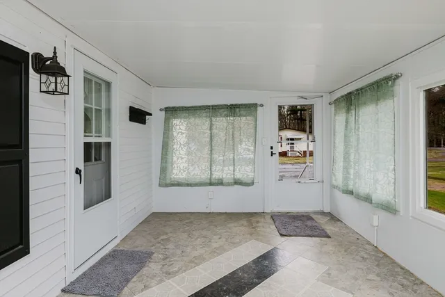 a view of room with window and refrigerator