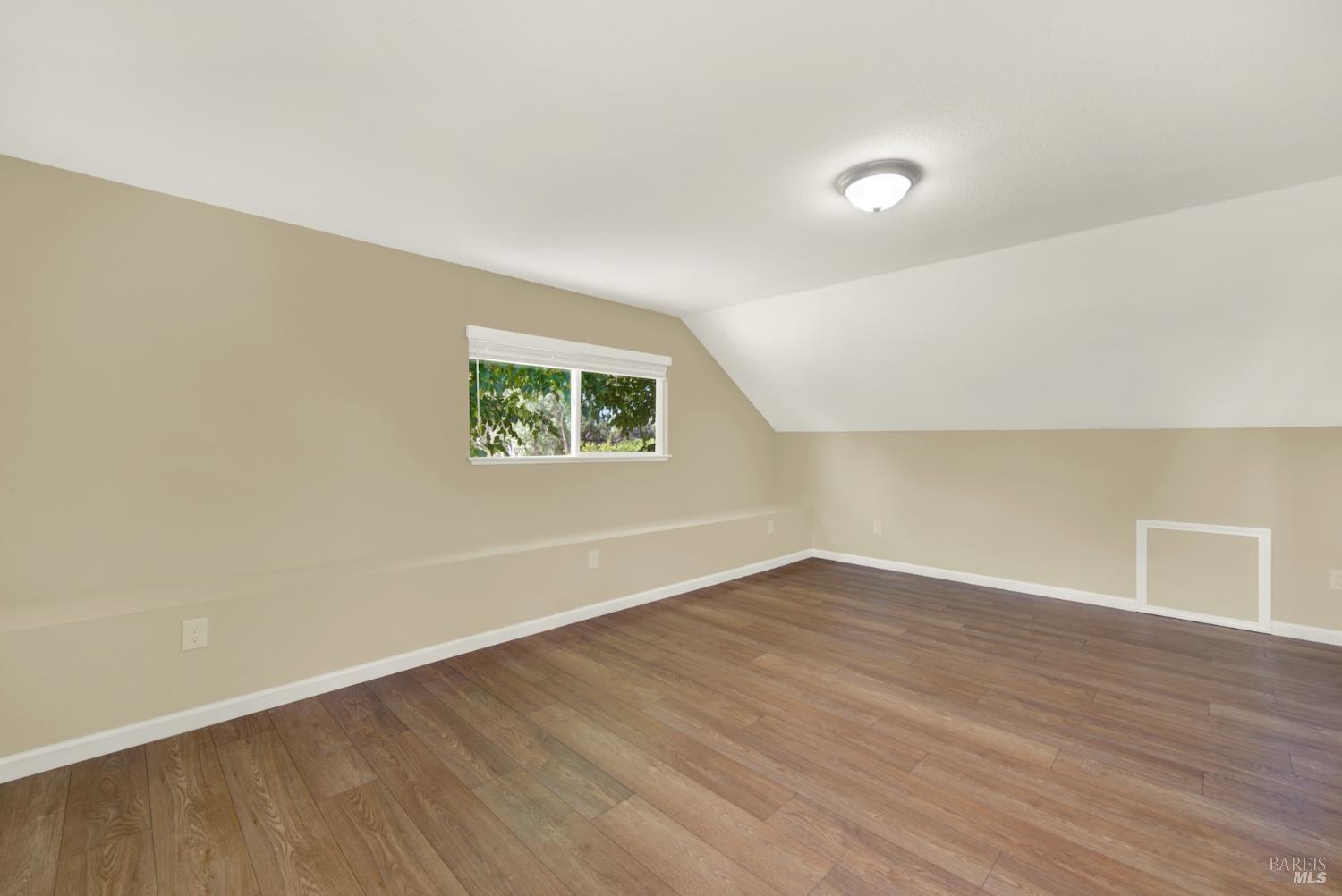 4851 Udell Road Vacaville, CA 95688 - Photo 23 of 65 an empty room with wooden floor and windows