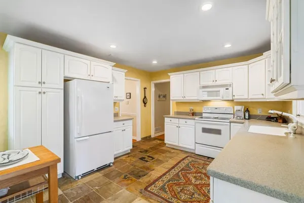 a large kitchen with a sink and cabinets