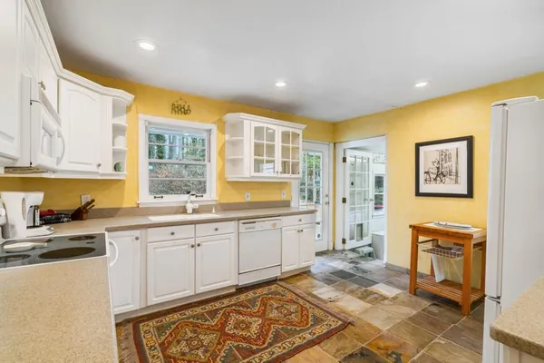 a kitchen with a sink stove and refrigerator
