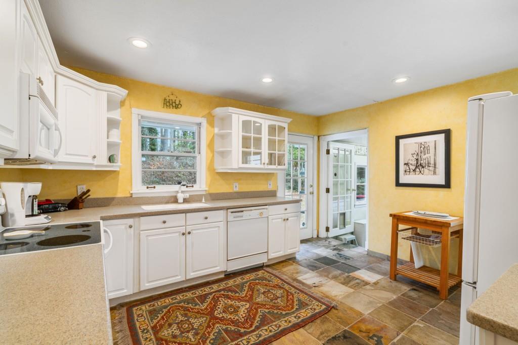 2368 Peeler Road Dunwoody, GA 30338 - Photo 13 of 47 a large kitchen with a sink and cabinets