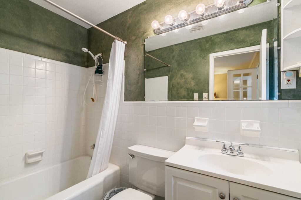 2368 Peeler Road Dunwoody, GA 30338 - Photo 19 of 47 a bathroom with a sink a toilet and shower