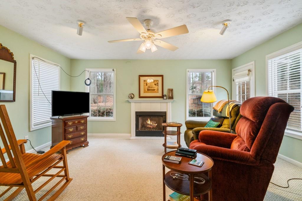 2368 Peeler Road Dunwoody, GA 30338 - Photo 21 of 47 a living room with furniture a flat screen tv and a fireplace
