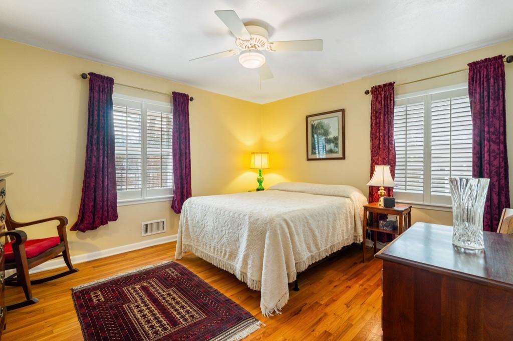 2368 Peeler Road Dunwoody, GA 30338 - Photo 23 of 47 a bedroom with a bed and wooden floor