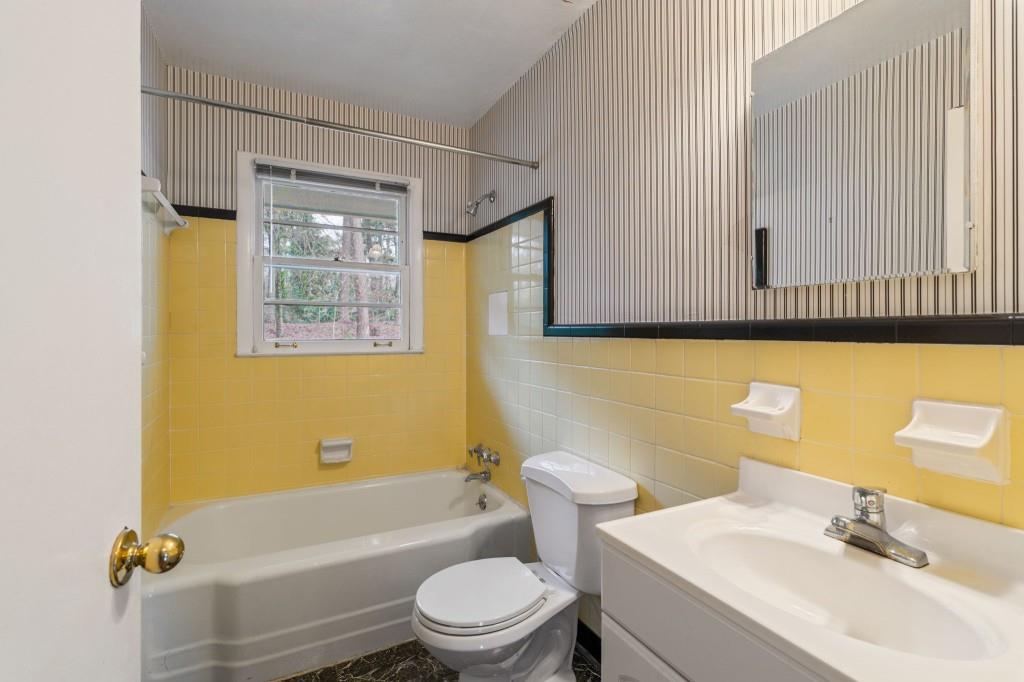 2368 Peeler Road Dunwoody, GA 30338 - Photo 24 of 47 a bathroom with a sink a toilet and a bathtub