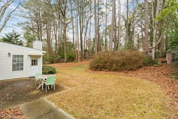 a backyard of a house with large trees