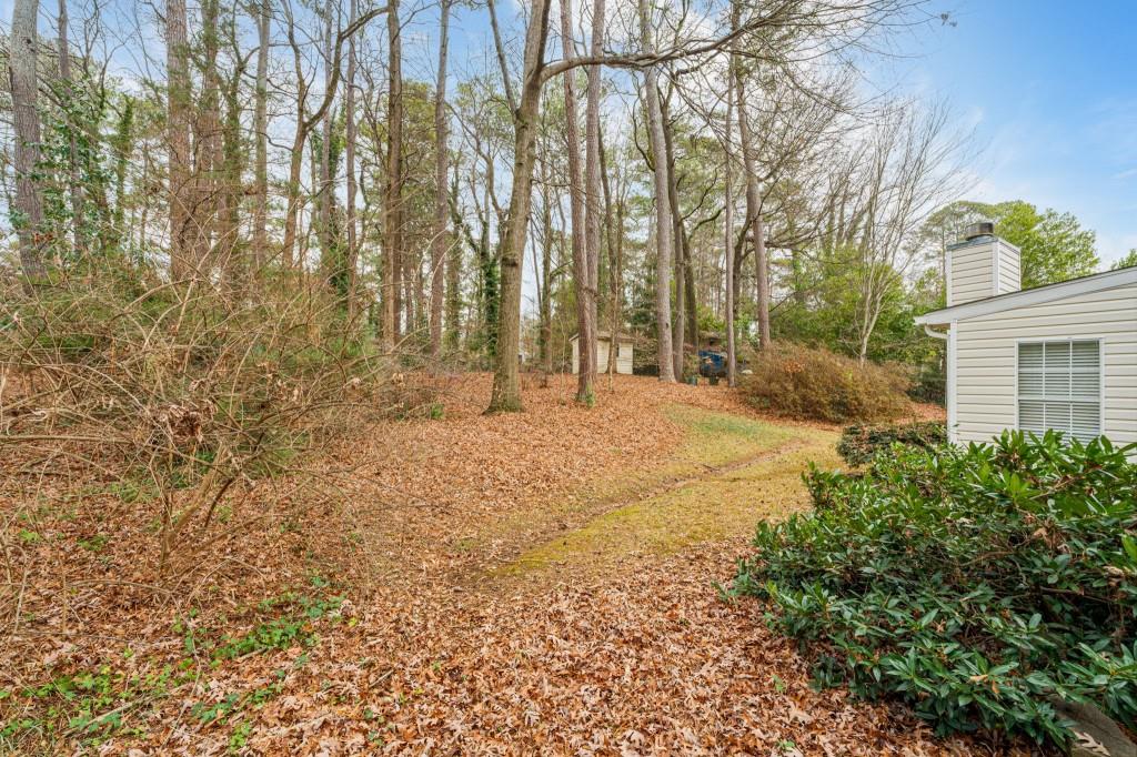2368 Peeler Road Dunwoody, GA 30338 - Photo 29 of 47 a backyard of a house with large trees