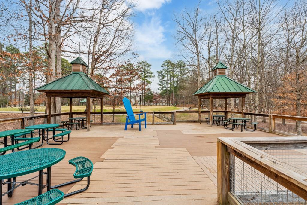 2368 Peeler Road Dunwoody, GA 30338 - Photo 40 of 47 a patio with a table and chairs under an umbrella