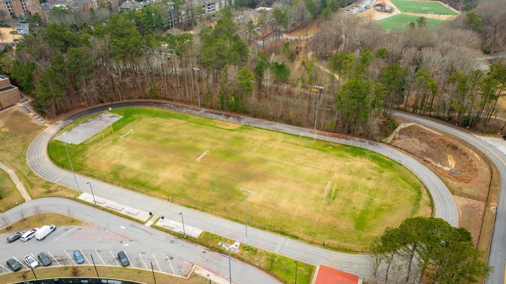 2368 Peeler Road Dunwoody, GA 30338 - Photo 43 of 47 a blue swimming pool with a garden