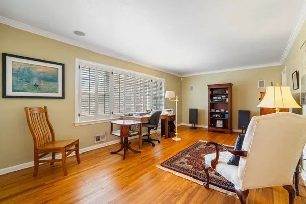 a living room with furniture a rug and a floor to ceiling window