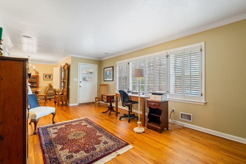 2368 Peeler Road Dunwoody, GA 30338 - Photo 6 of 47 a living room with furniture a rug and a floor to ceiling window