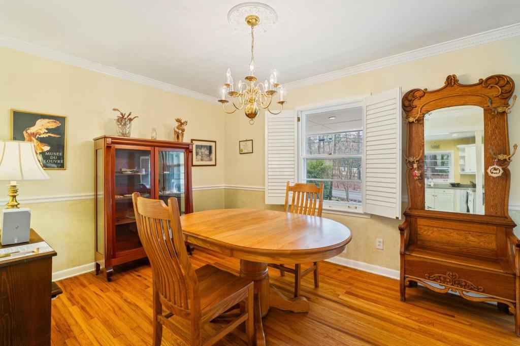 2368 Peeler Road Dunwoody, GA 30338 - Photo 9 of 47 a dining room with furniture a chandelier and wooden floor