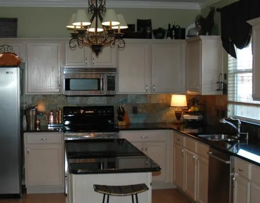 a kitchen with a sink and steel appliances