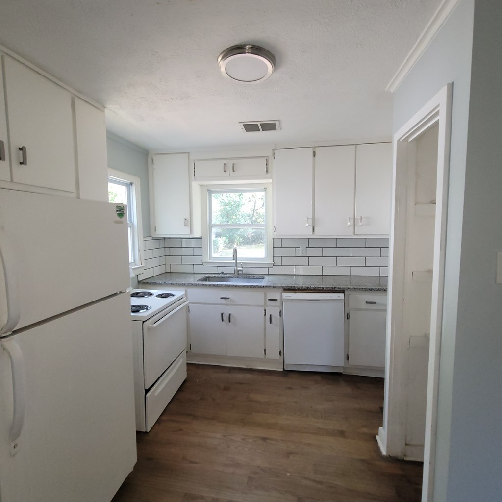 2719 Lee Street Columbus, GA 31903 - Photo 4 of 8 a kitchen with a sink cabinets stainless steel appliances and a window